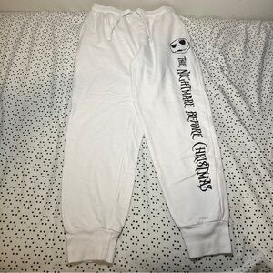 White sweatpants with The Night Before Christmas ontheleft with jackskellington.